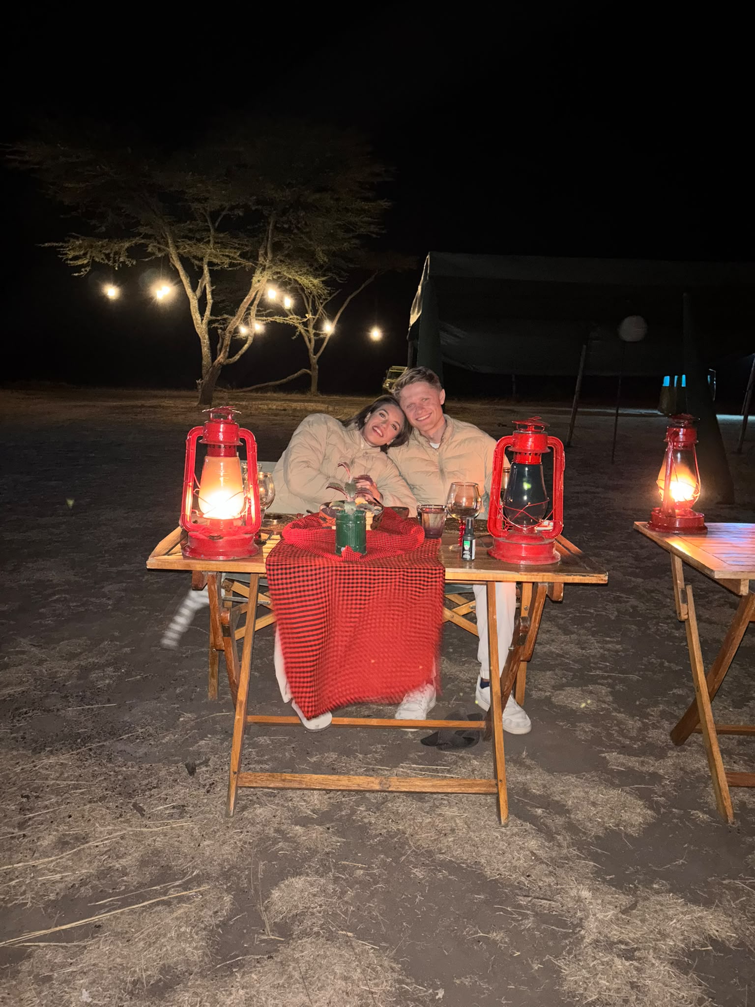 Couple celebrating honeymoon with champagne on Tanzania safari